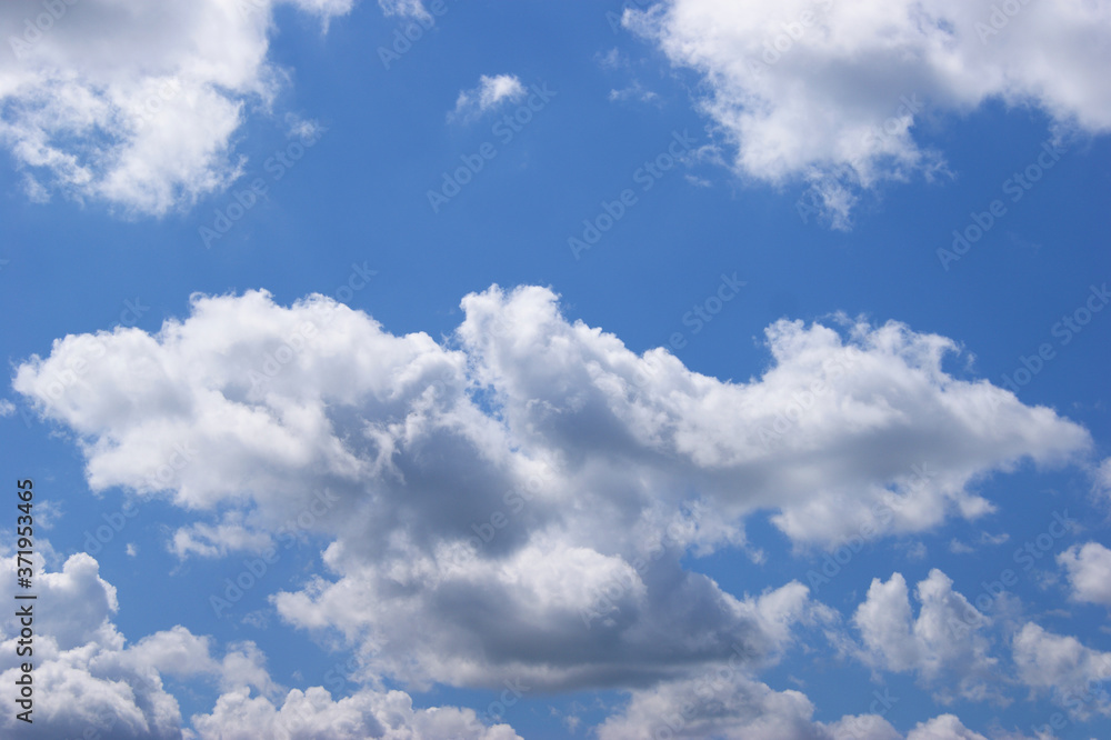 Fototapeta premium Light blue sky background with clouds.