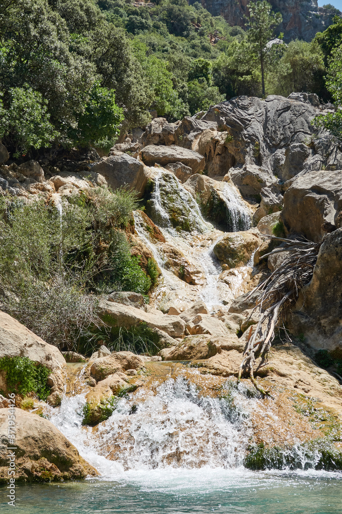 Waterfalls of the Guadalquivir river as it passes through the Utrero enclosure in the Sierra de Cazorla, Segura and Las Villas Natural Park. Jaen. Andalusia. Spain