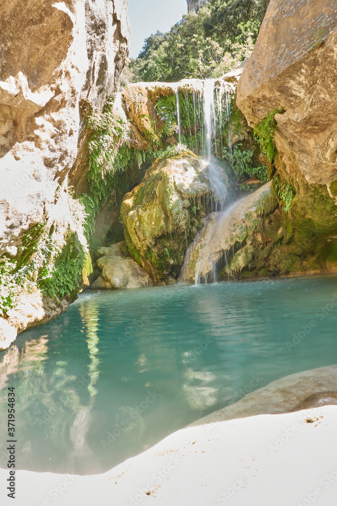 Naklejka premium Waterfalls of the Guadalquivir river as it passes through the Utrero enclosure in the Sierra de Cazorla, Segura and Las Villas Natural Park. Jaen. Andalusia. Spain