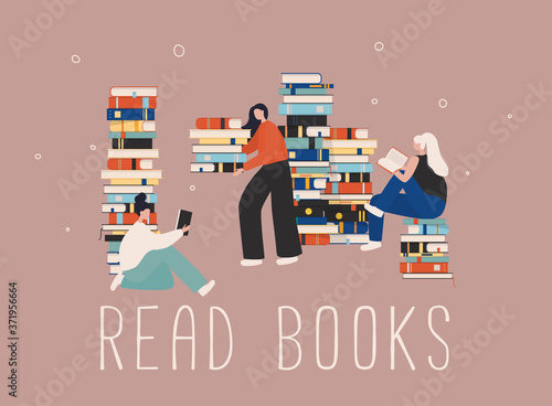 Young stylish female readers sitting on stack of giant books or beside it and reading.