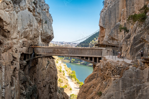 El Chorro, Spain. El Caminito del Rey walkway along the steep walls of a narrow gorge in El Chorro with spectacular old stone bridge joining vertical rocks, Spain.