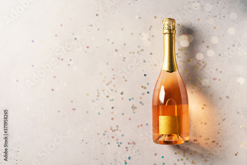 Bottle of rose sparkling wine on grey background © Denira
