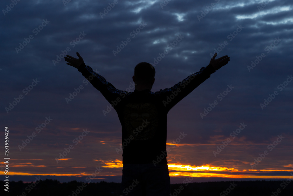 Fototapeta premium dark silhouette of a man on a sunset background