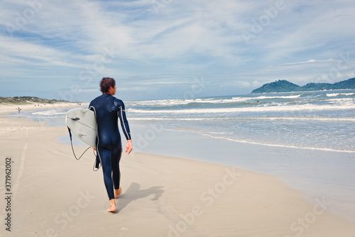 Beautiful scenic beach view at sunset with surfer siluette on the ocean beach, Florianopolis, Brasil, South America