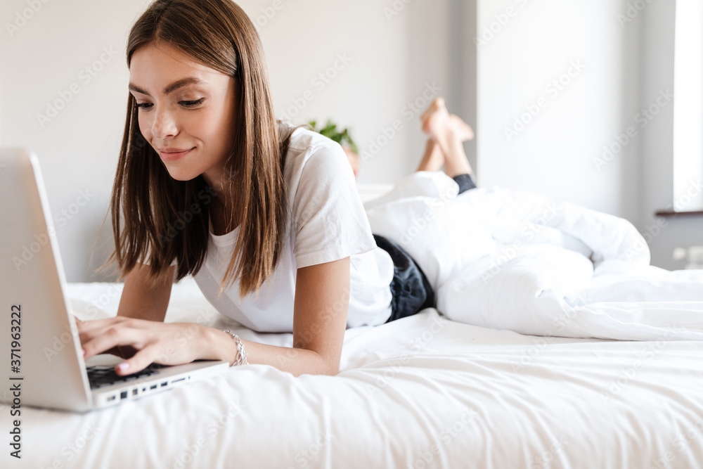 Attractive young woman using laptop computer Attractive young woman using laptop computer
