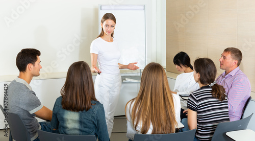 Female manager making presentation on staff meeting at office