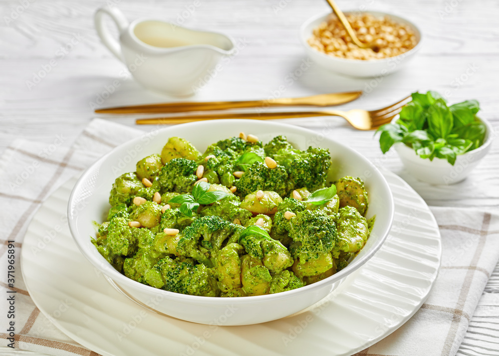 gnocchi with broccoli in a white bowl
