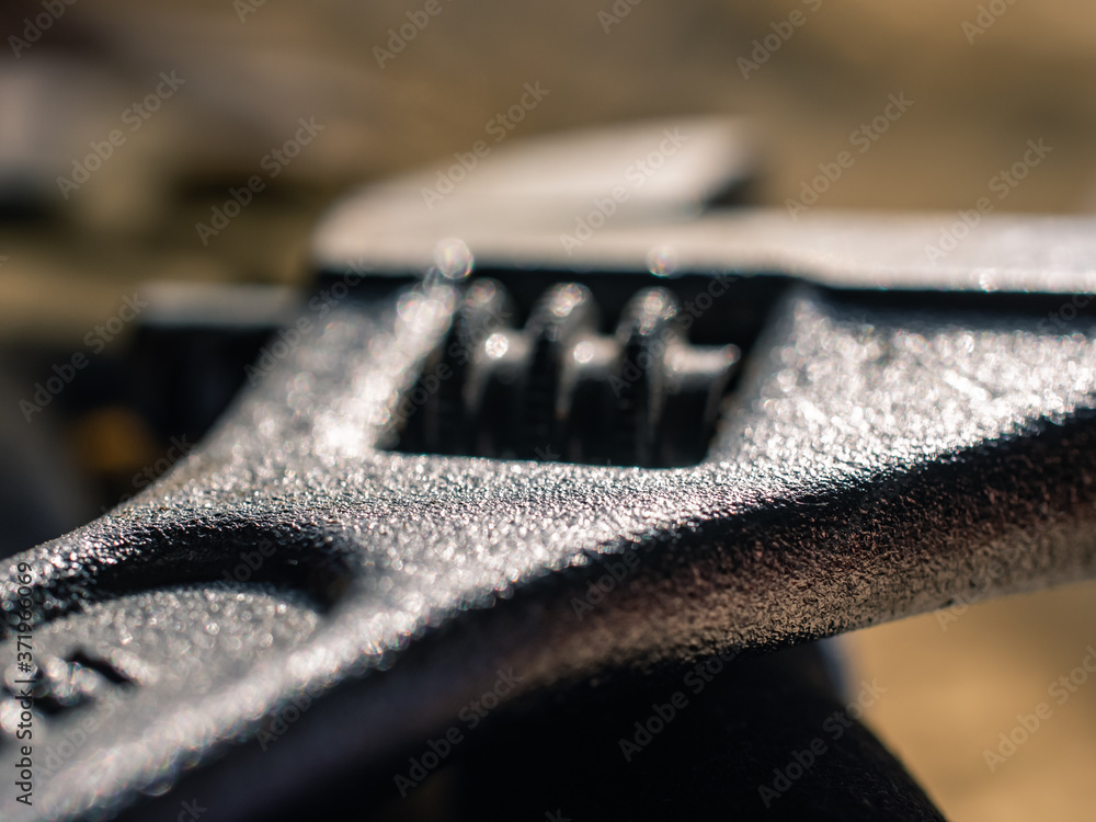 close up of an adjustable wrench close up of an adjustable wrench