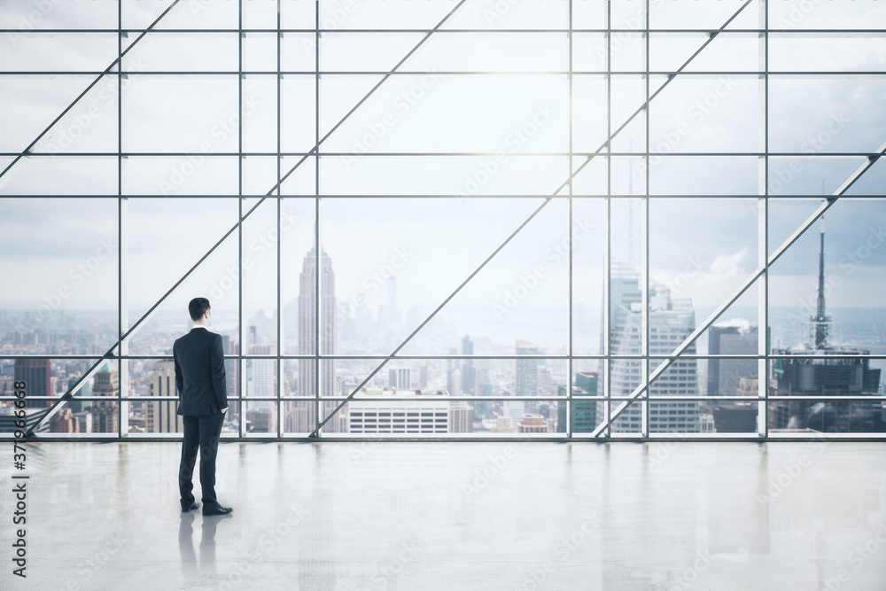 Businessman standing in luxury boarding room interior with city view Businessman standing in luxury boarding room interior with city view
