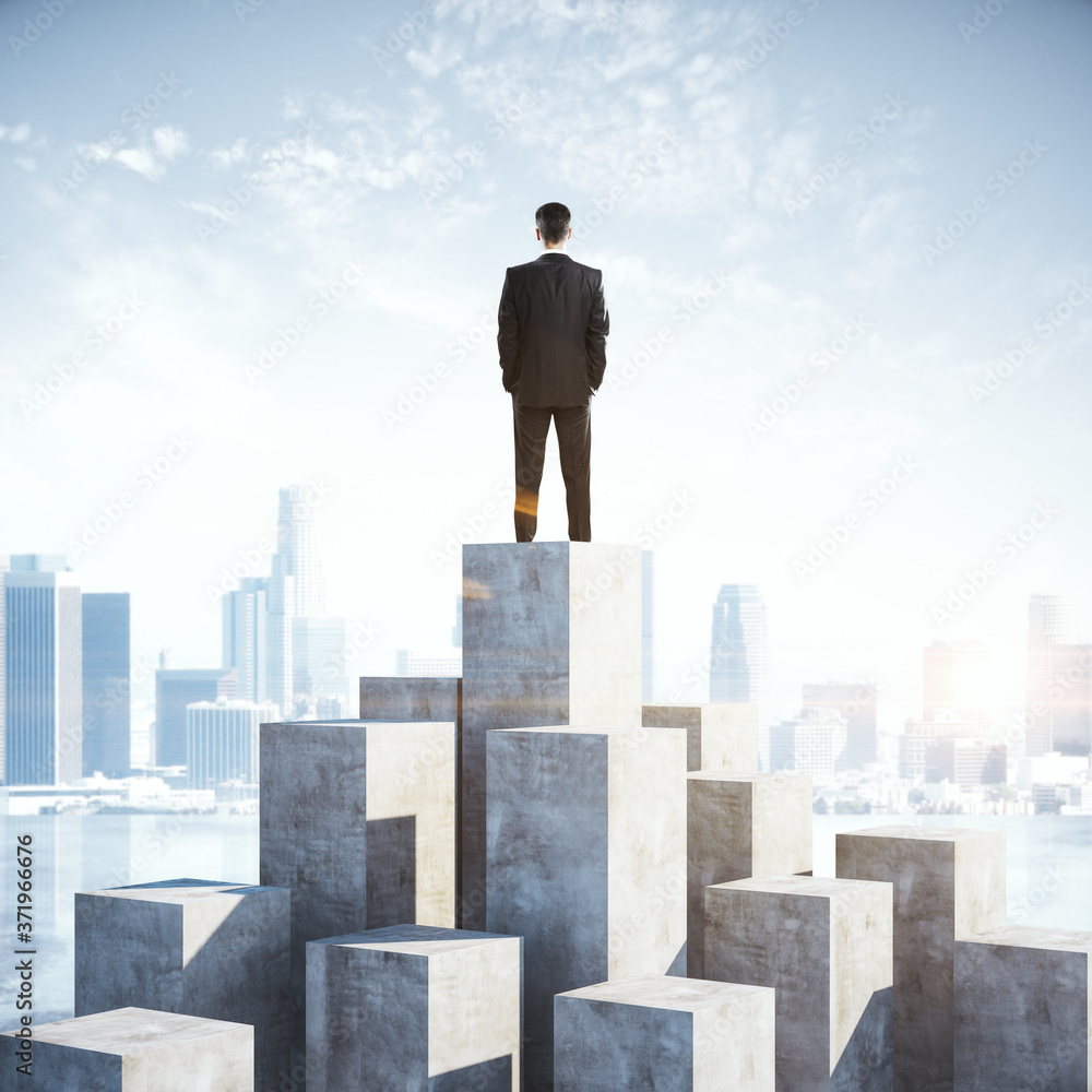 Businessman standing on cube and looking on city. Businessman standing on cube and looking on city.