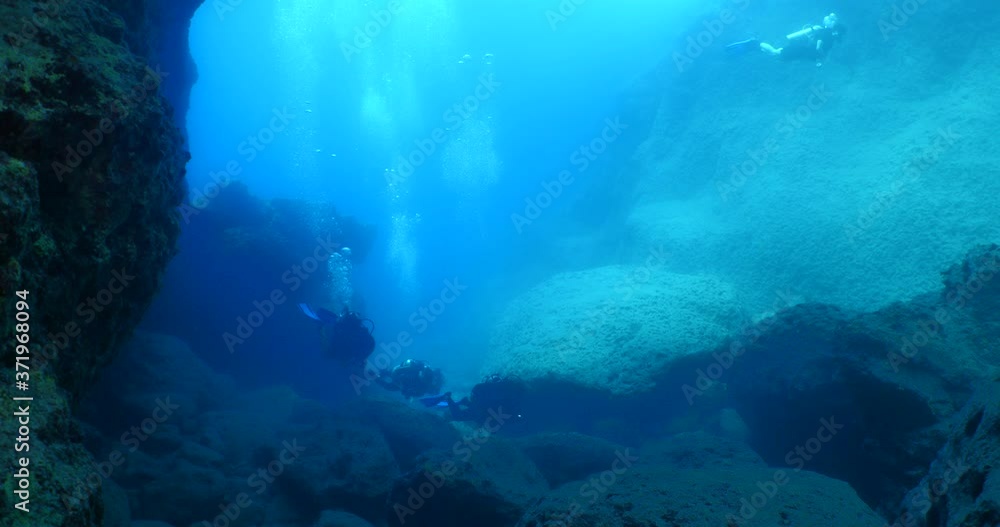 scuba divers exploring the reefs underwater with rocks ocean scenery enjoying topography mediterranean sea scuba divers exploring the reefs underwater with rocks ocean scenery enjoying topography mediterranean sea