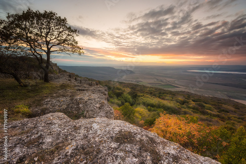 Amazing view from a hill with an autumn forest at sunset © Jess_Ivanova