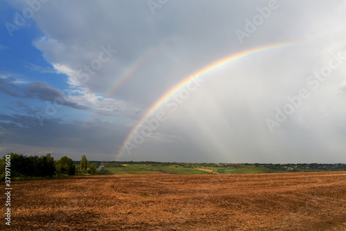 Double rainbow over fields and road. © Ann Stryzhekin