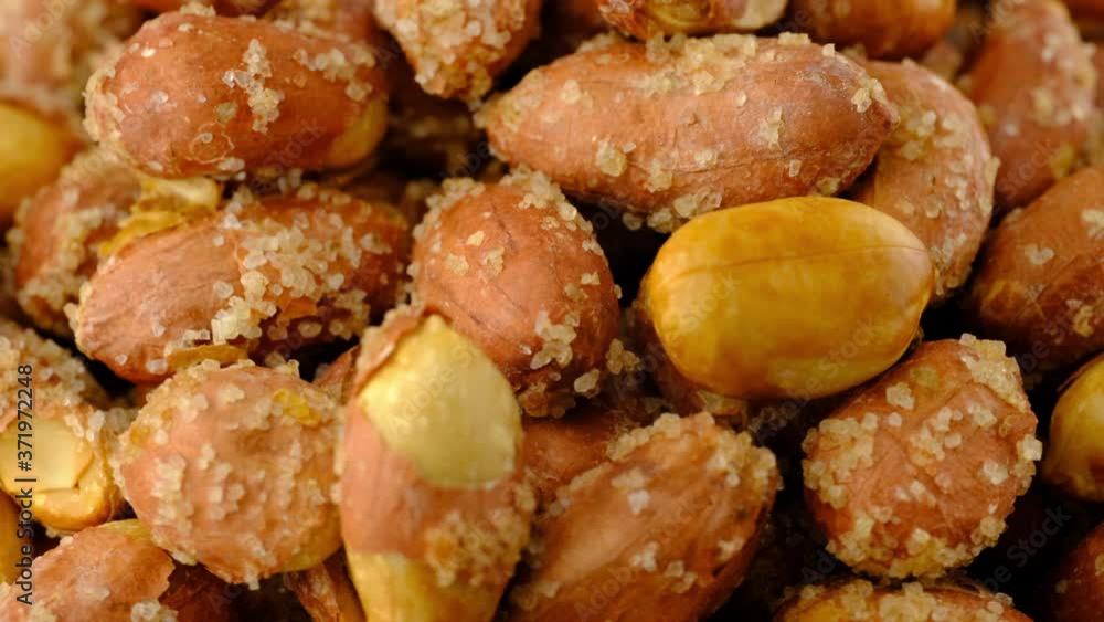 Peanuts macro background texture. Roasted salty nuts closeup rotating. Peanuts macro background texture. Roasted salty nuts closeup rotating.