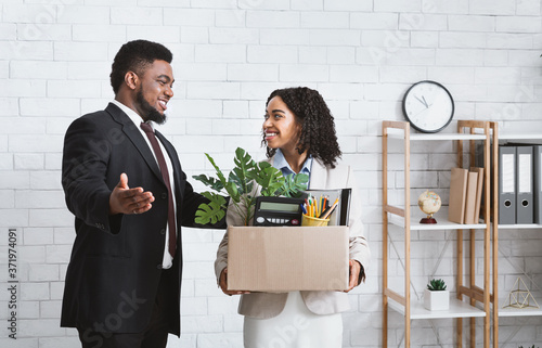 First day at office. African American businessman welcoming new female employee to his team at office photo