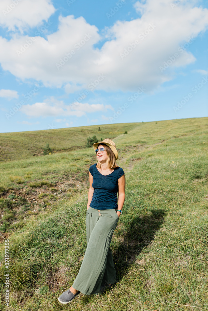 Young woman enjoying on the hillside meadows Young woman enjoying on the hillside meadows