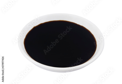 Soy sauce in small white bowl isolated on white background