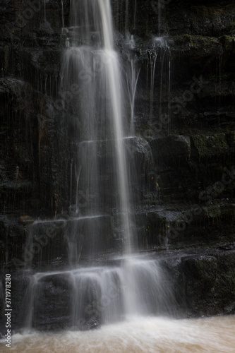 Close up of a small waterfall in the Ribble valley. Falling water into a deep pool.