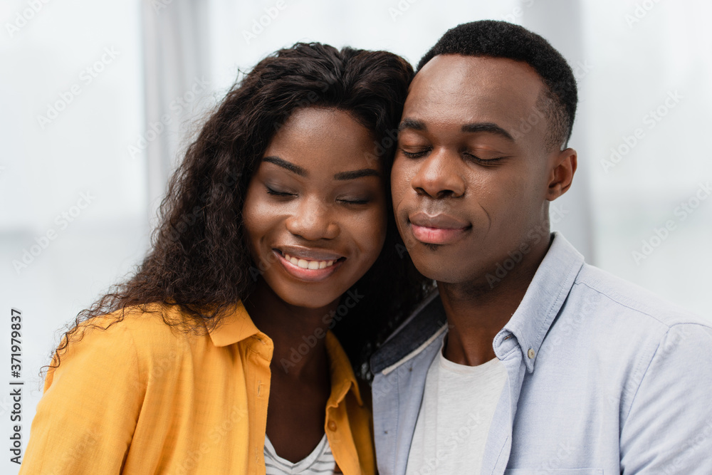african american man and brunette woman with closed eyes african american man and brunette woman with closed eyes