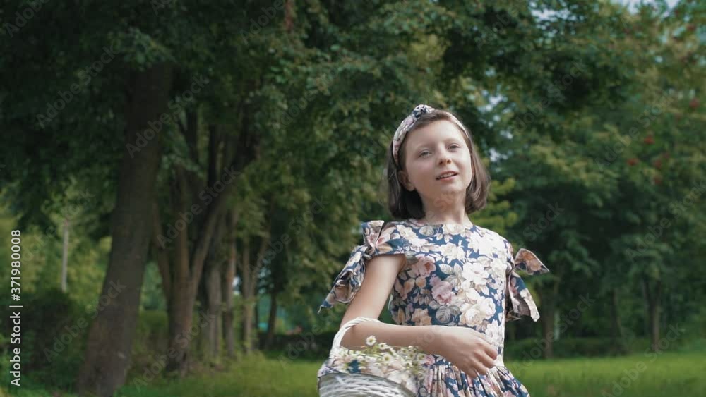 girl in a delicate dress with a basket of flowers in her hands dances in nature girl in a delicate dress with a basket of flowers in her hands dances in nature