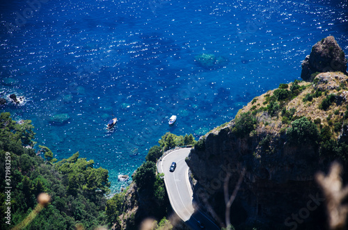 Amalfi Coast - Detail of Hairpin bend, cliff, turquoise sea and boats. View from Sentiero degli Dei - Path of Gods.