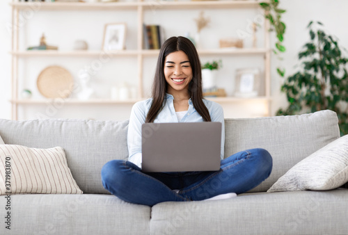 Freelance Concept. Smiling Korean Girl Working Online On Laptop At Home