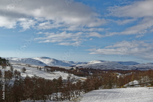 Fototapeta Naklejka Na Ścianę i Meble -  Looking over the Valley's of Glen Esk and Glen Clova, on a cold Afternoon in February under a light Blue Sky with White Clouds.