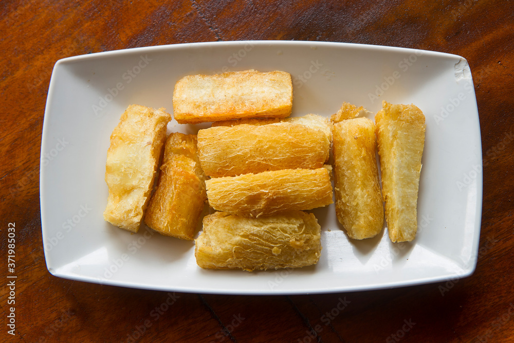 Deep fried cassava root . Brazilian Mandioca Frita (deep fried cassava/ manioc/yuca). Feijoada side dish Deep fried cassava root . Brazilian Mandioca Frita (deep fried cassava/ manioc/yuca). Feijoada side dish