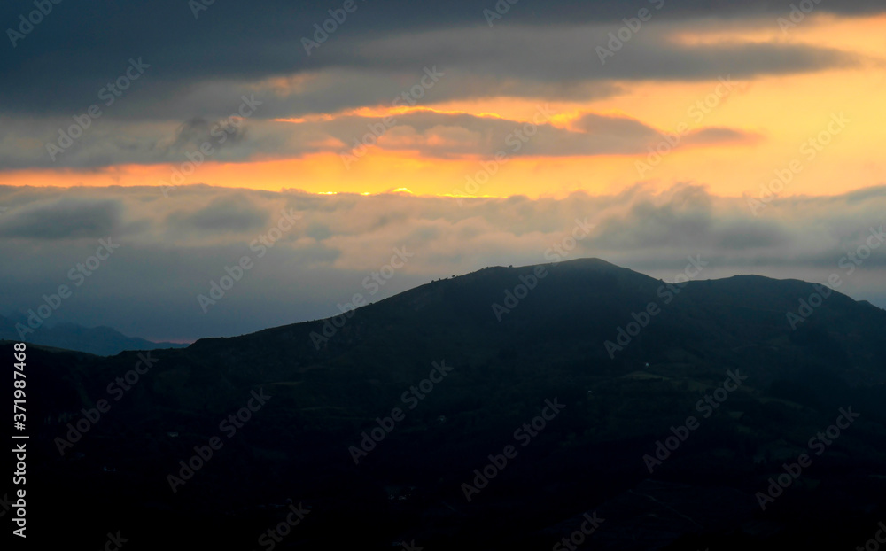Sunset from Mount Ubieta, with the sun through the clouds