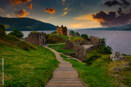 Urquhart Castle at sunset located on the banks of loch ness, scotland. photo
