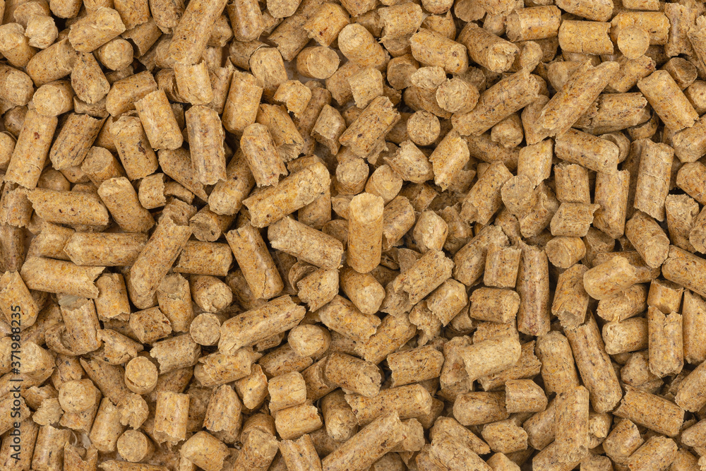 Brown wood pellets texture background. natural pile of wood pellets. organic biofuels. Alternative biofuel from sawdust. The cat litter. pile of compressed wood pellets. Brown wood pellets texture background. natural pile of wood pellets. organic biofuels. Alternative biofuel from sawdust. The cat litter. pile of compressed wood pellets.
