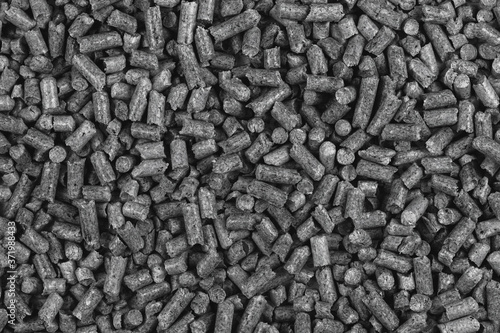 White and black wood pellets texture background. natural pile of wood pellets. organic biofuels. Alternative biofuel from sawdust. pile of compressed wood pellets