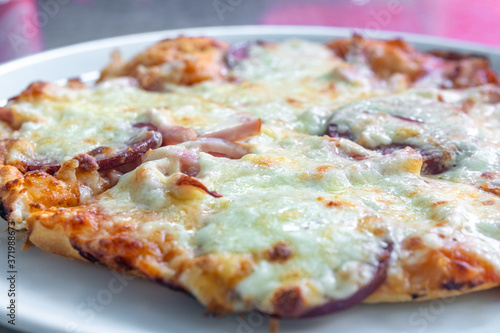 Homemade pizza with vegetables, salami and mayonnaise