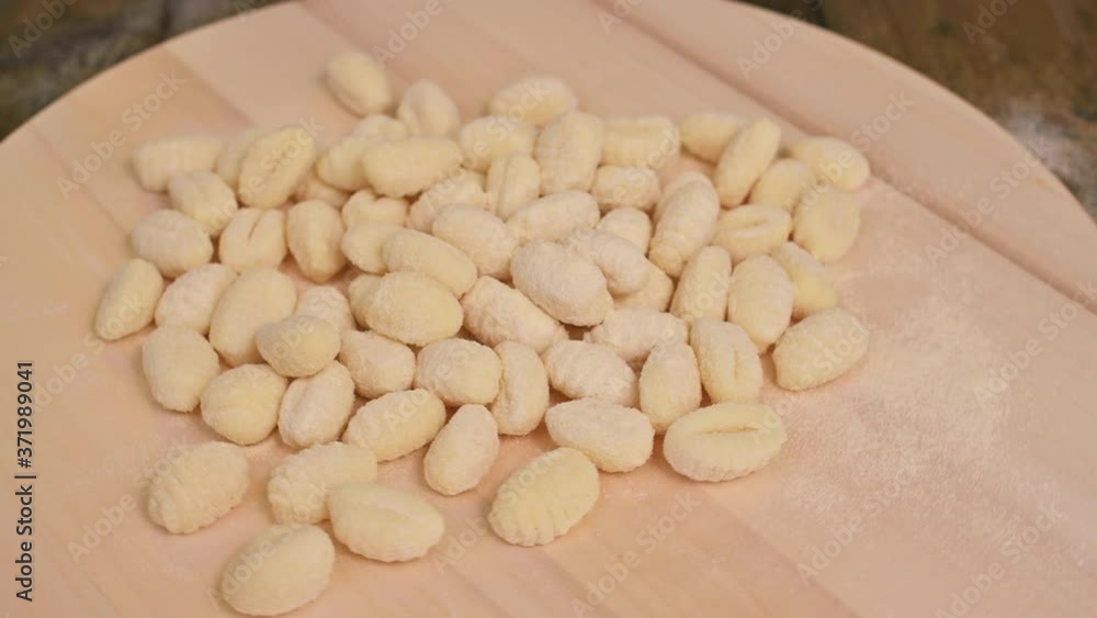 Gnocchi with potatoes. Traditional italian food from Rome, Sardinia, south of italy. Homemade gnocchi with parmesan, egg, cornmeal (semolina). On a wooden table. High quality photo. Above. Copy space Gnocchi with potatoes. Traditional italian food from Rome, Sardinia, south of italy. Homemade gnocchi with parmesan, egg, cornmeal (semolina). On a wooden table. High quality photo. Above. Copy space