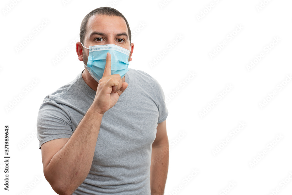 Adult man making be quiet gesture wearing mask with copyspace Adult man making be quiet gesture wearing mask with copyspace