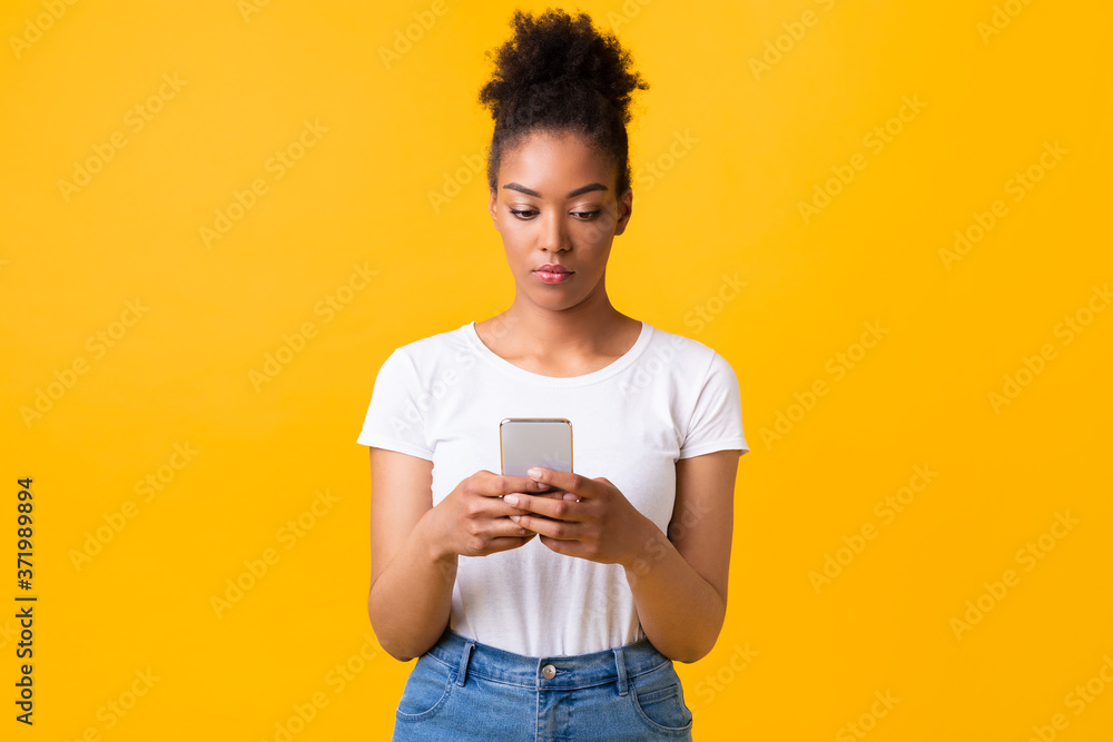 Focused afro girl using cell phone at studio Focused afro girl using cell phone at studio