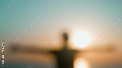 Wallpaper Mural Morning workout. Warm up and stretching before training on the sea pier. Young man practicing youga against the backdrop of the sea and the rising sun. Sport activity. Athlete silhouette.  Torontodigital.ca