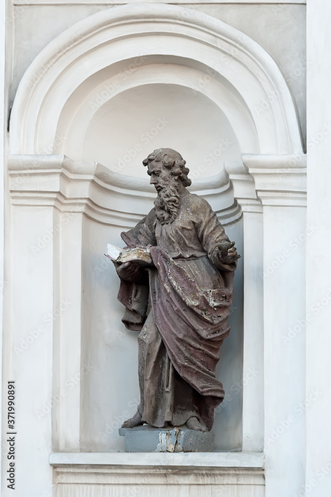 St Peter sculpture in a niche on facade of Saint Peter and Paul Cathedral, Lutsk, Ukraine