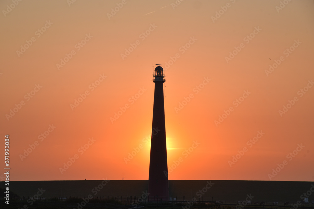 lighthouse of den helder, holland against the sunset.