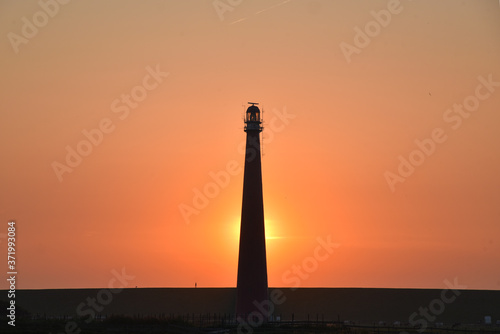 lighthouse of den helder, holland against the sunset.