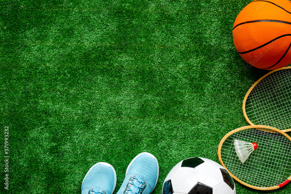Obraz premium Frame of sport balls - football, basketball on football field. Copy space