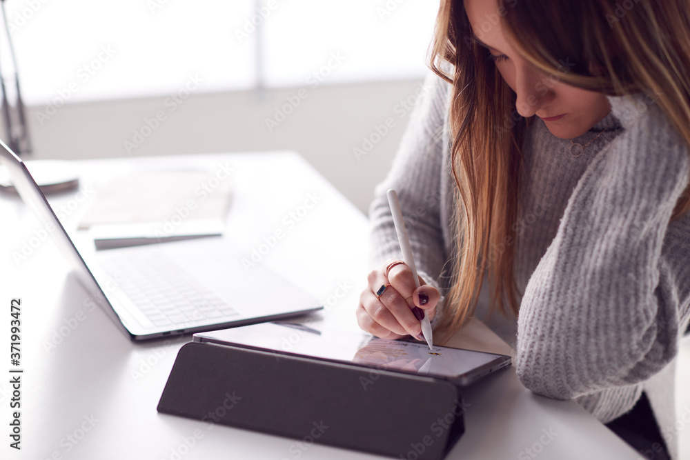 Businesswoman Working From Home Drawing On Digital Tablet Using Stylus Pen Businesswoman Working From Home Drawing On Digital Tablet Using Stylus Pen
