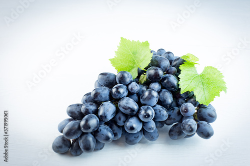 Bunch of grapes on a light background, horizontally.