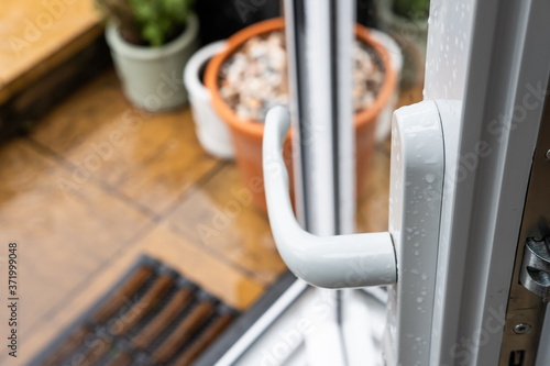 Canvastavla Shallow focus of a newly installed uPVC patio door, seen opened leading to a wet patio area at the back of a house
