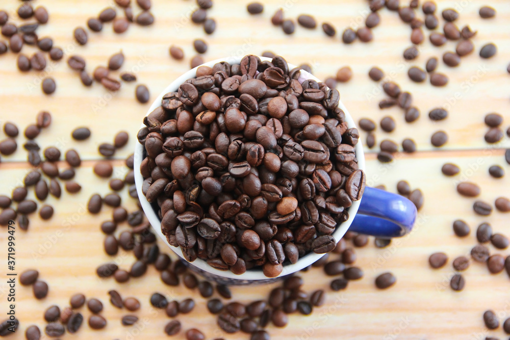 natural black coffee beans and ceramic blue a mug natural black coffee beans and ceramic blue a mug