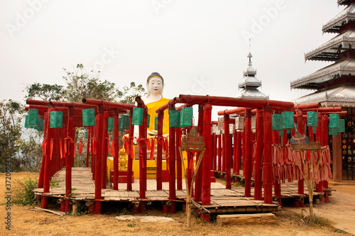 Big buddha statue and red Torii in Wat Phu Sa Ma with Su Tong Pae bridge for thai people and foreign travelers travel visit respect praying at Pai while PM 2.5 Dust situation in Mae Hong Son, Thailand