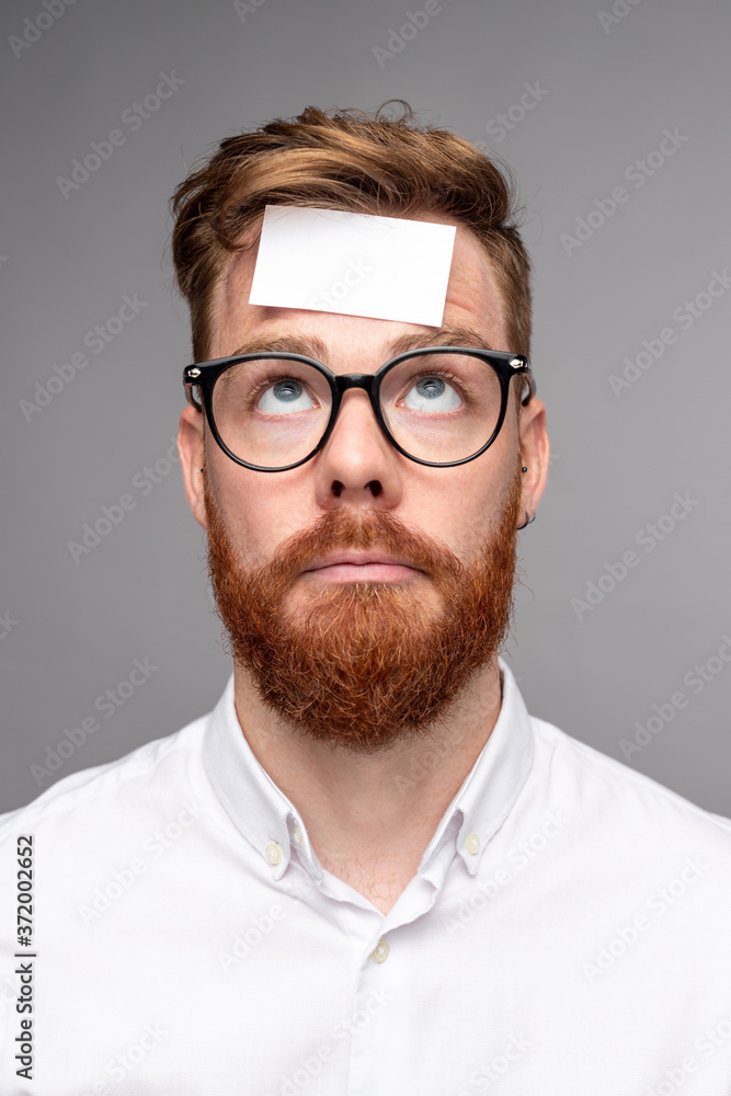 Puzzled man with sticker on forehead Puzzled man with sticker on forehead