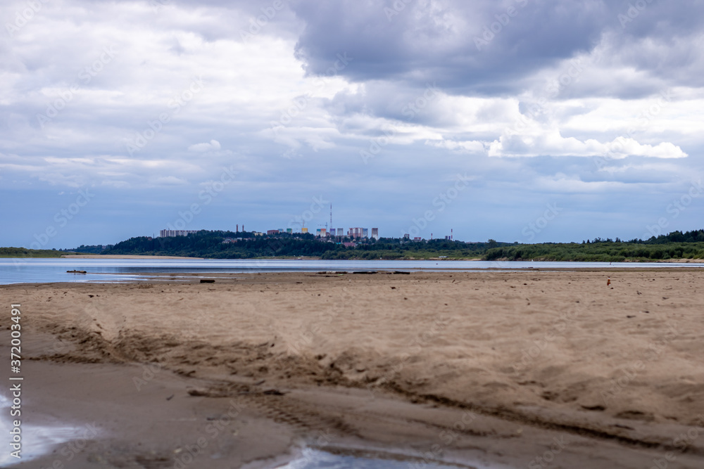 Sandy beach in cloudy weather. Bank of the river. Sandy beach in cloudy weather. Bank of the river.