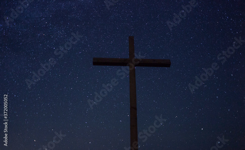 A Christian cross on a starry night