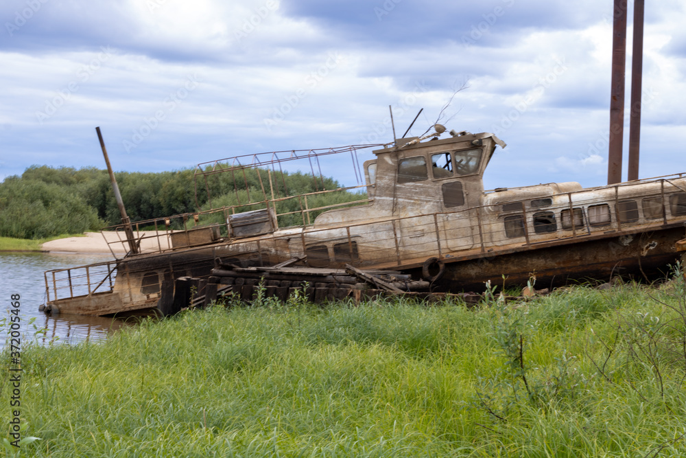 Fototapeta premium Old abandoned boat on the river. Old passenger boat.